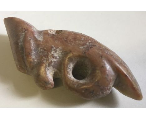 A South American carved green and russet jade pendant Worked as a bird. 7 cm long.   CONDITION REPORTS:  Generally in good co