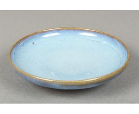 A Chinese Jun-ware porcelain dishWith allover mottled blue glaze, standing on a shallow foot.  15 cm wide.    CONDITION REPOR