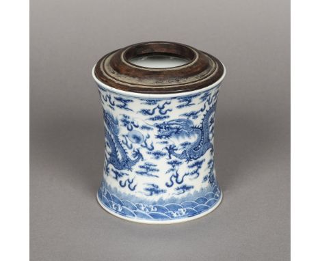 A Chinese blue and white porcelain brush potOf waisted cylindrical form, decorated with five clawed dragons chasing a flaming