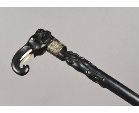 A Colonial ivory and silver mounted carved ebony walking stick, hallmarks indistinctThe handle formed as an elephant mask ove