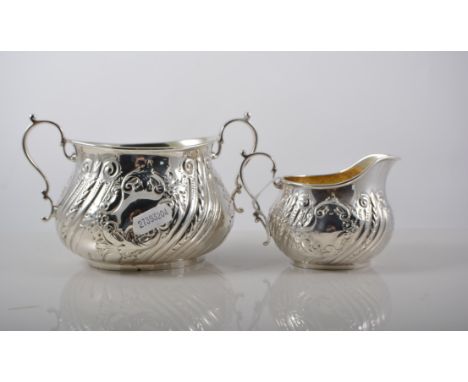 Victorian silver three piece teaset comprising teapot, milk jug and sugar bowl, embossed, blank cartouches, Martin Hall & Co.