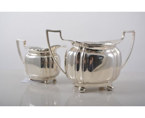 Silver three piece teaset, shaped oval form, on paw feet, C.B. & S., Sheffield, various dates, teapot with ebonised handle an