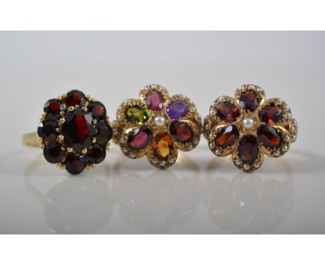 9ct gold garnet and pearl cluster ring, another similar and another garnet set dress ring, (3).