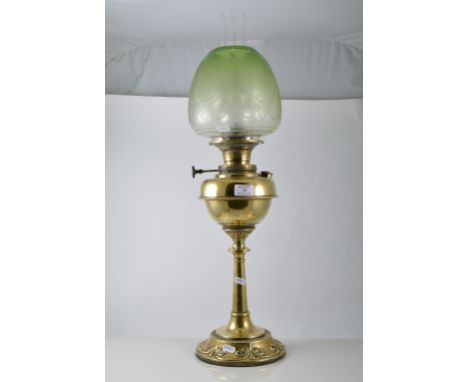 Brass oil lamp with a bead and swag base, plain column and brass reservoir, plain glass chimney with an etched glass shade, 6