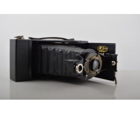 Pair of French mother of pearl mounted opera glasses, another pair of opera glasses, surveyor's tape, bellows camera, two pai