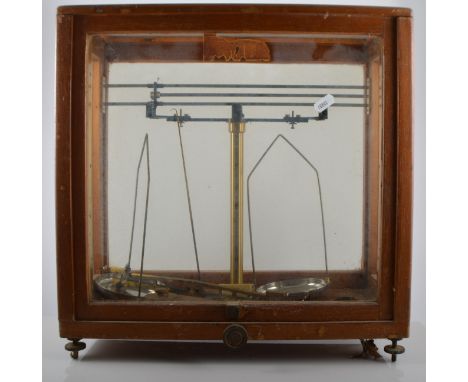 Set of Pharmaceutical beam balance scales, in a wooded case, width 42cm.