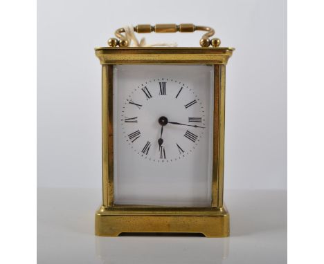 French timepiece with Roman numeral chapter ring,  brass case, oval glass revealing escapement, height 12cm.