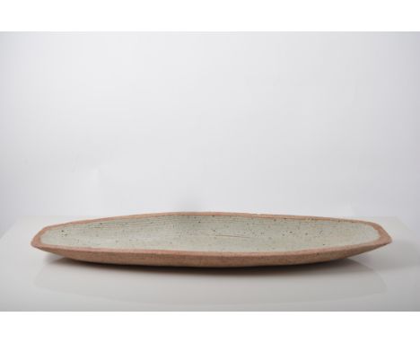 David Leach stoneware dish, ovoid form, oatmeal glaze, incised wave design, impressed seal mark, 46cm long, together with a q