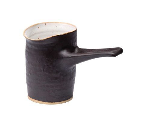 Dame Lucie Rie (1902-1995) and Hans Coper (1920-1981): A Stoneware Pouring Vessel, circa 1960, manganese glaze with a pitted 
