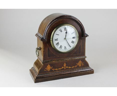 An Edwardian inlaid mahogany mantel clock with white enamel dial, in domed case, with brass side handles, 21cm high