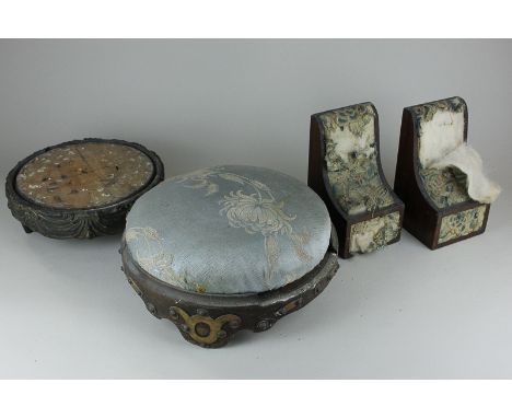 A pair of wooden bookends with tapestry panels (now in poor condition), 18cm, two circular footstools (one with missing top),