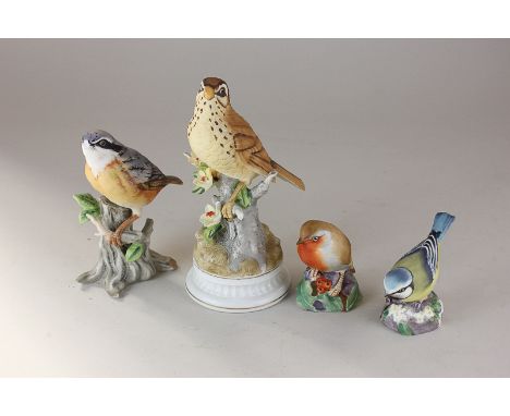 Two Royal Worcester porcelain models of birds, a robin and a bluetit, together with two Spanish ornaments of birds (one a/f)