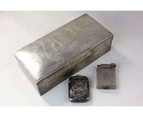 A George V silver cigarette box, London 1924 (monogrammed), a silver vesta case bearing the crest and motto of the City of Ca