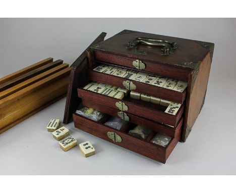 A bone and bamboo mahjong set in brass mounted fitted wooden case, together with four pine tile stands