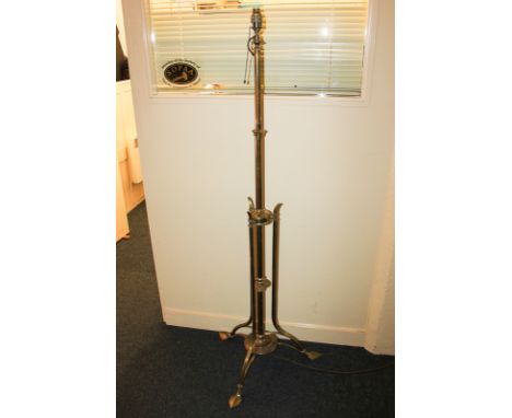 After Benson, Art Nouveau brass standard lamp, on tripod base with leaf shaped feet 154cm