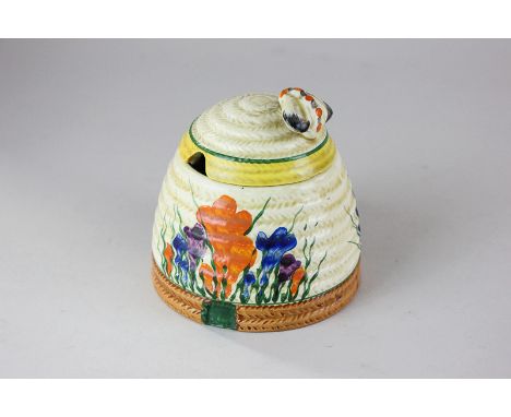 A Clarice Cliff Bizarre crocus pattern honey pot in the form of a beehive with cover and bee handles, printed mark to base