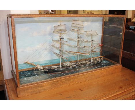 A model of the Cutty Sark tea clipper sailing ship in glazed case with card marked Model 'By' R B Askew, 71cm by 40cm by 23cm