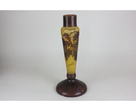 A cameo glass lamp base decorated with oak leaves and acorns, in tones of brown, marked Gallé, 31cm