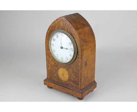 An Edwardian mantel clock in burr wood lancet shaped case, on brass button feet, 22cm, (NC)