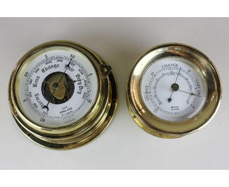 A brass bulkhead barometer marked FCC Precision, 12cm, and another with hinged dial, 15cm