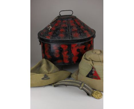 A military safari helmet with brass badge HWA, a bush hat with military badge initialled, and a metal hat case (NC)