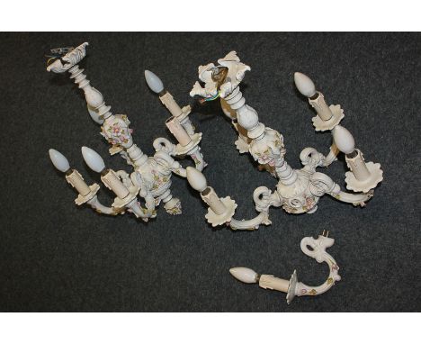 A pair of Naples porcelain candelabra light fittings with five sconces, decorated with bocage floral design (a/f - must be te