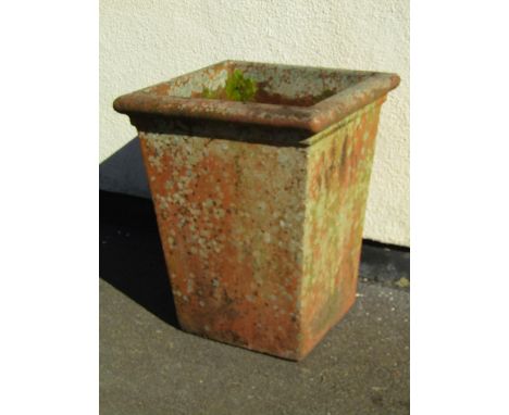 A large weathered terracotta planter of squared form, 71cm high, 56cm diameter