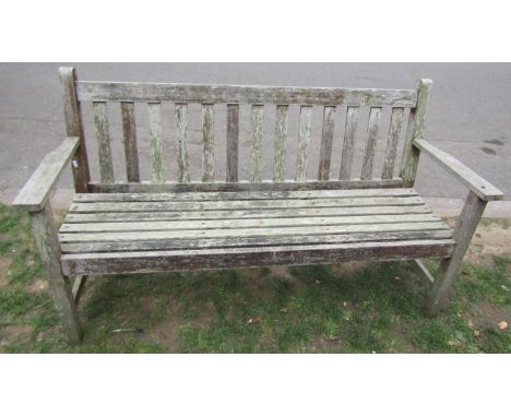 A Barlow Tyrie weathered three seat garden bench with slatted seat and back, 151cm long