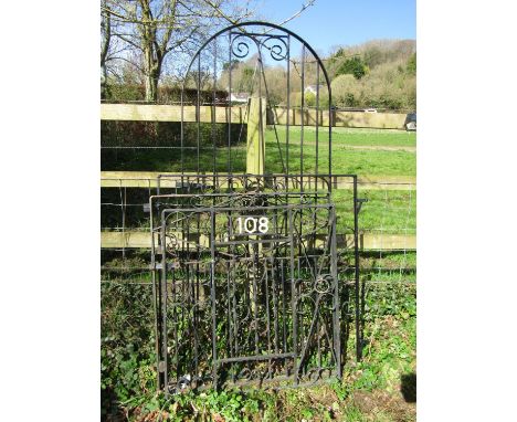 A painted ironwork arch pedestrian or side gate with scrolling detail, together with three others of varying sizes (4)