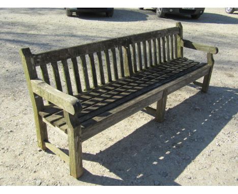 A large weathered / silvered teak park or country house garden bench, with slatted back and seat, 240cm long