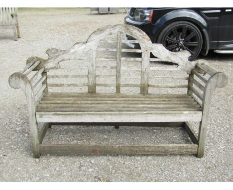 A weathered (silvered) Lutyens style teak two seat garden bench 158 cm (af) 