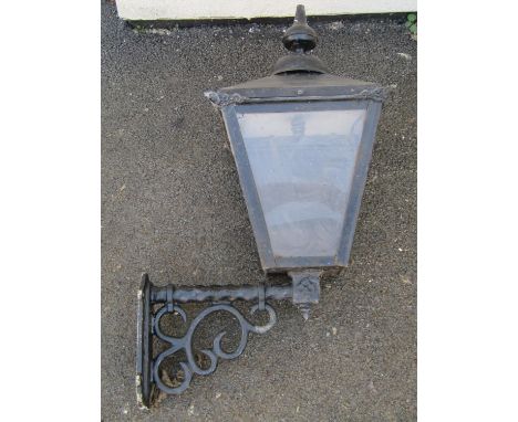 A Georgian style porch / wall lantern, with lacquered metalwork frame and perspex panels, on wall mounting bracket, the lante