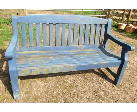 A heavy gauge weathered wooden three seat  garden bench with slatted seat and back beneath an arched rail (painted blue) 153 