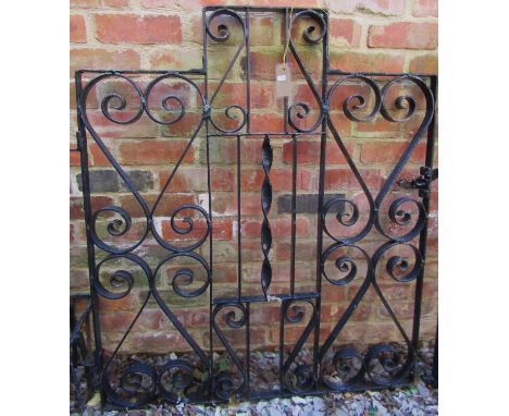 A heavy gauge iron work pedestrian/side gate of stepped form, with decorative open scroll detail, 116cm high x 105cm wide