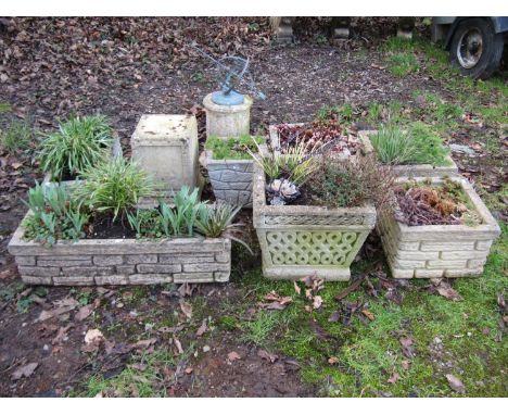 Six weathered mock stone wall effect planters of varying size and design, one other, a square cut and stepped urn pedestal an