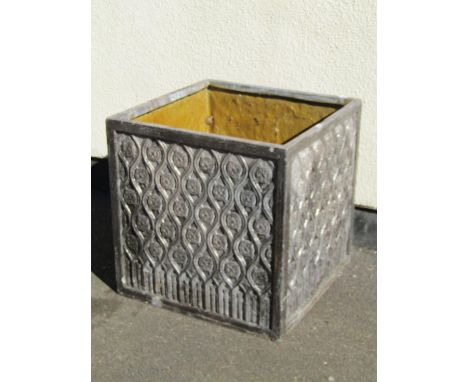 A large decorative faux lead planter of squared form with moulded foliate roundel decoration, 55cm high, 56 x 56cm