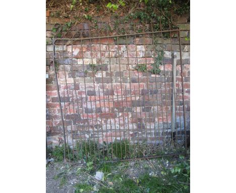 An old wrought iron gate with simple open vertical rails and decorative repeating C scroll detail, (af) 166cm high x 152cm wi
