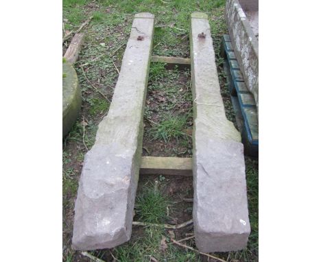 A pair of carved natural stone gate posts with arched cruciform shaped caps, 206 cm (full height) x 18 cm x 14 cm