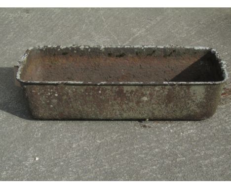 A large old weathered iron feeder / trough of rectangular form, 27cm high, 104 x 43cm.