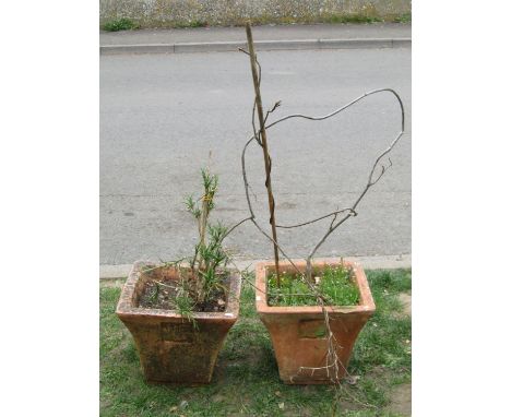 A pair of weathered terracotta planters of flared square tapered form, with repeating leaf moulded detail, (planter af) 35cm 