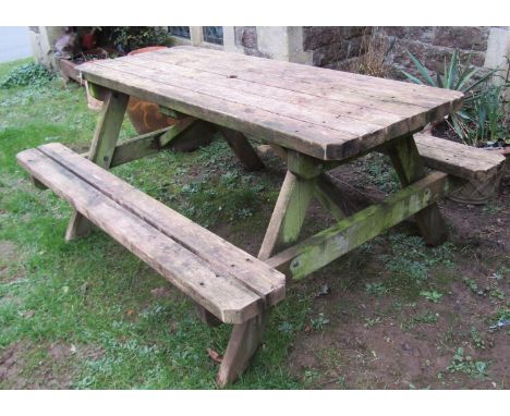 A heavy gauge weathered softwood picnic bench, 74 cm high x 160 cm x 132 cm