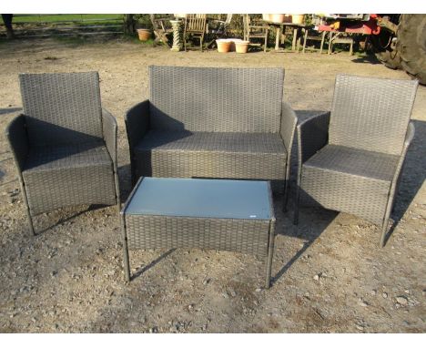 A contemporary weathered four piece garden patio/conservatory rattan suite comprising two seat sofa, pair of armchairs and re