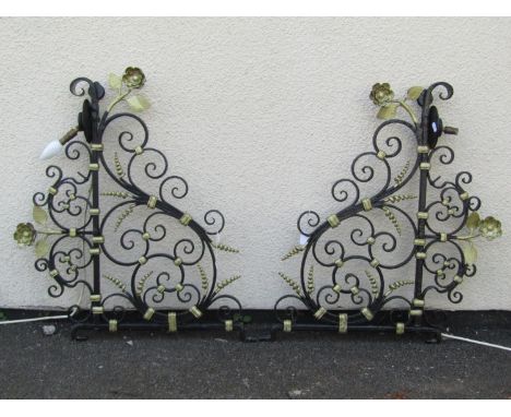 A pair of later painted and gilt ironwork light brackets / wall hanging sconces, with scrolling frame, foliate and floral dec