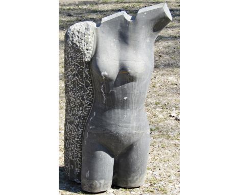 A large and heavy post-modern carved slate garden ornament in the form of a stylised female torso, with polished and rough he