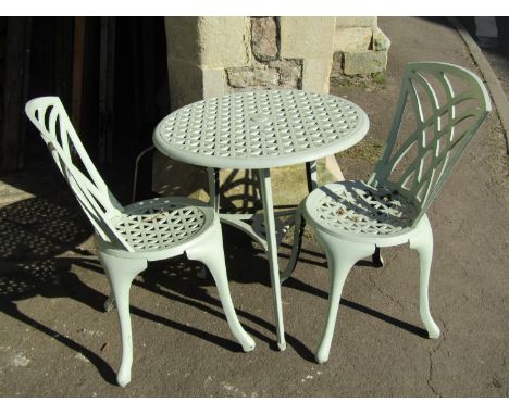 A light green painted cast aluminium three piece garden terrace set with pierced lattice detail 