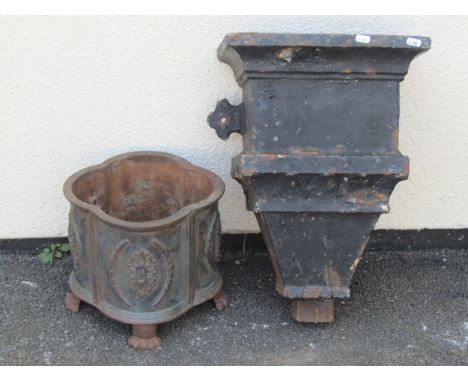 Cast iron quatrefoil shaped planter with repeating foliate detail and paw feet, 26cm high x 30cm together with a large cast i
