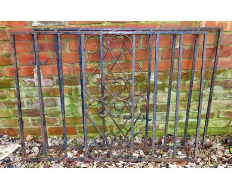 A pair of heavy gauge ironwork driveway entrance gates, with vertical open square rails flanking a  central open scroll panel