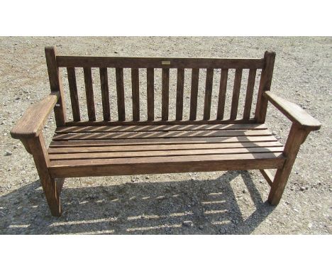 A 'Barlow Tyrie' of Braintree, stained teak three seat garden bench with slatted seat and back, 160 cm