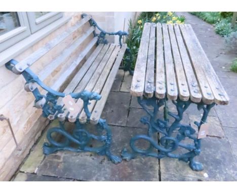 A Victorian style cast iron garden bench with hound head supports and timber lathes together with a matching garden table wit
