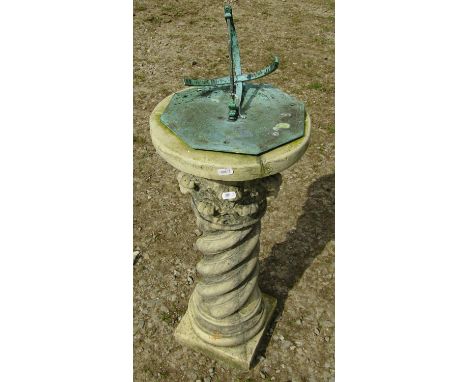 A weathered garden sundial with octagonal plate, set on a spiral column pedestal, 85cm (full height) x 30cm diameter